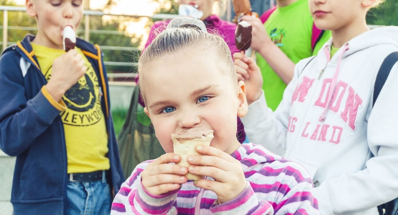 boy in white and pink striped long sleeve shirt holding ice cream, Nutritional Habits in Children