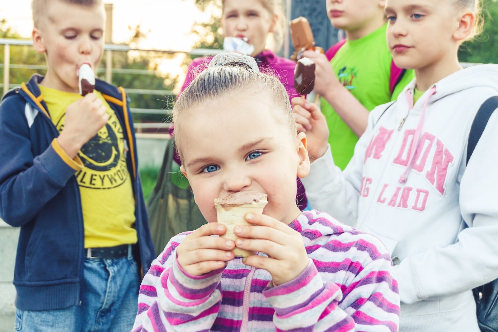 boy in white and pink striped long sleeve shirt holding ice cream, Nutritional Habits in Children